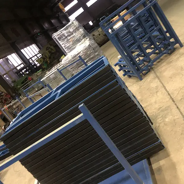 Blue transport rack holding upright slabs inside an industrial workshop