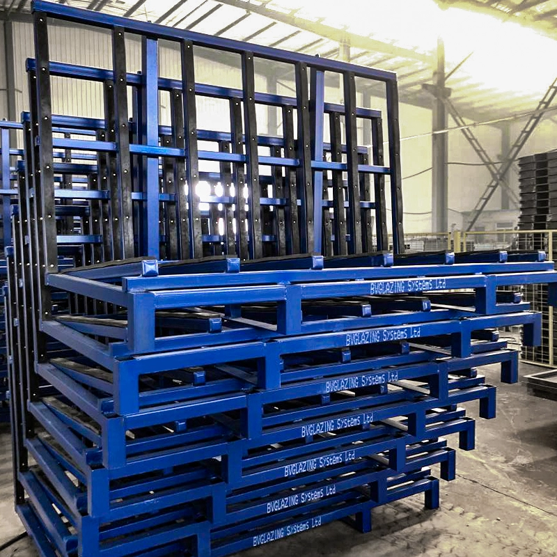 High-density nested stack of 7 empty blue L-shape returnable glass transport racks in a logistics depot